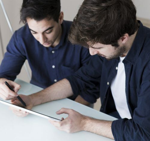 men-discussing-data-tablet men-discussing-data-tablet